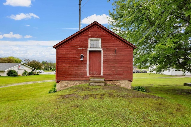 view of outbuilding featuring a yard