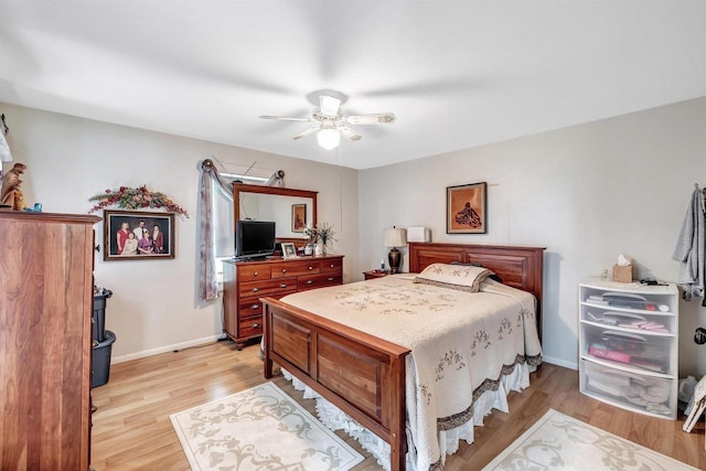 bedroom with ceiling fan and light hardwood / wood-style floors