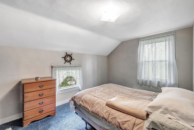 carpeted bedroom with lofted ceiling