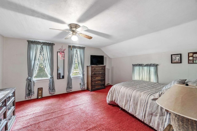 carpeted bedroom with ceiling fan and vaulted ceiling