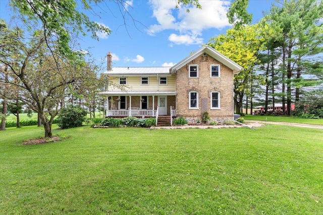 view of front of house with covered porch and a front yard