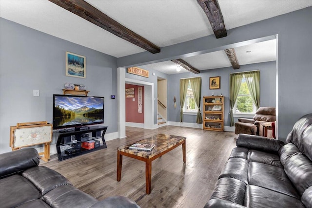 living room with beam ceiling, wood-type flooring, and a textured ceiling