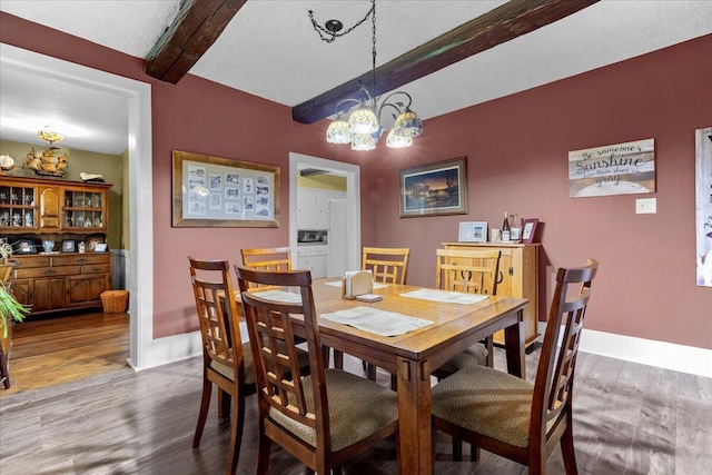 dining room featuring beamed ceiling, hardwood / wood-style floors, and a notable chandelier