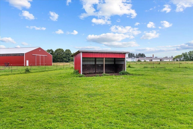 view of yard with a rural view and an outdoor structure