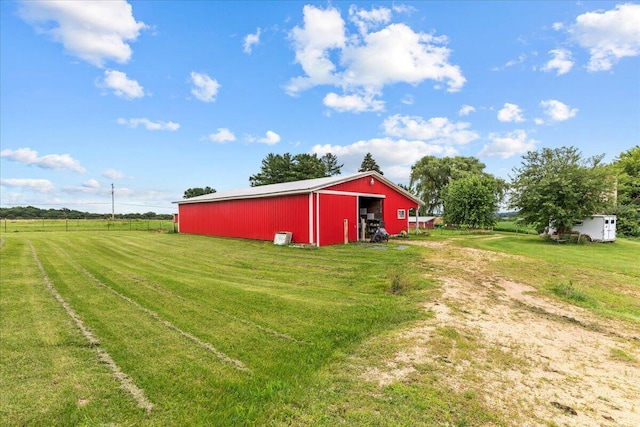 view of yard featuring an outbuilding and a rural view