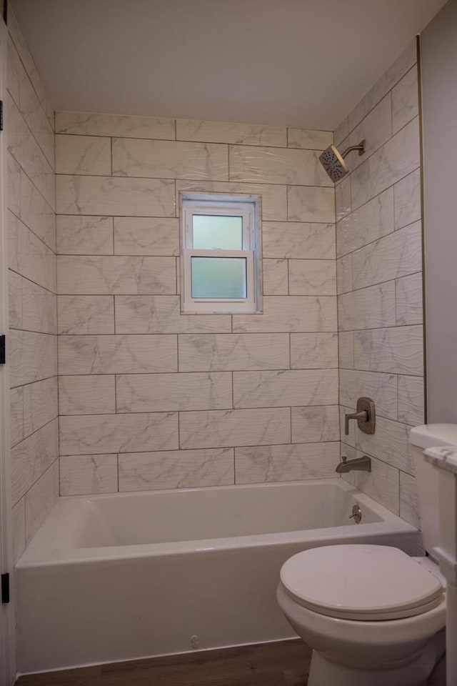 N9351 Juneau Ln, Necedah, WI 54646 - bathroom with wood-type flooring, tiled shower / bath combo, and toilet