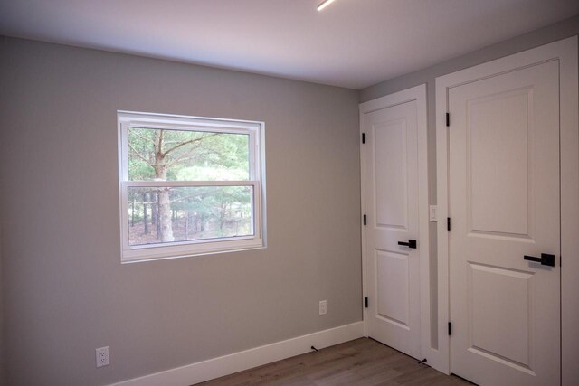 N9351 Juneau Ln, Necedah, WI 54646 - unfurnished bedroom with light wood-type flooring