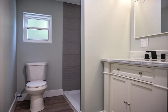 N9351 Juneau Ln, Necedah, WI 54646 - bathroom with hardwood / wood-style flooring, toilet, a shower, and vanity