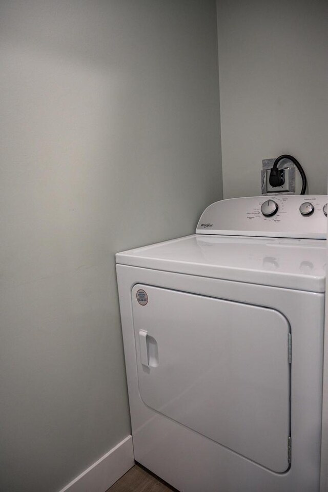 N9351 Juneau Ln, Necedah, WI 54646 - clothes washing area featuring hardwood / wood-style floors and washer / dryer