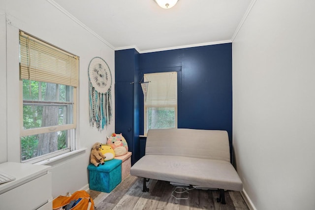 sitting room featuring hardwood / wood-style floors and ornamental molding