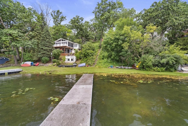 dock area with a water view and a lawn