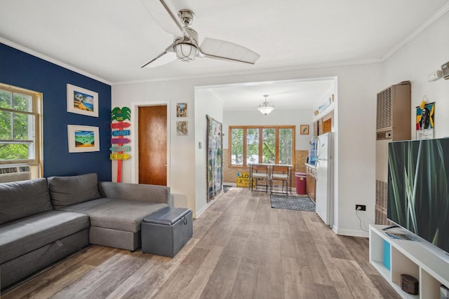 living room featuring ceiling fan, light hardwood / wood-style flooring, and ornamental molding