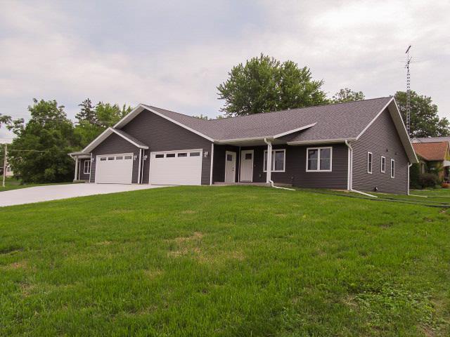 ranch-style house with a garage and a front yard