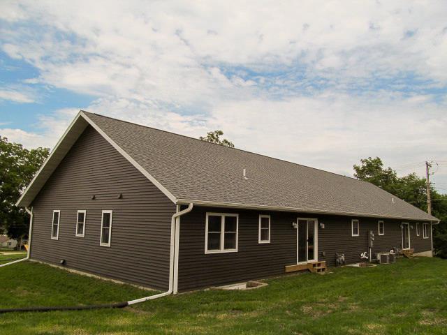 rear view of property with a yard