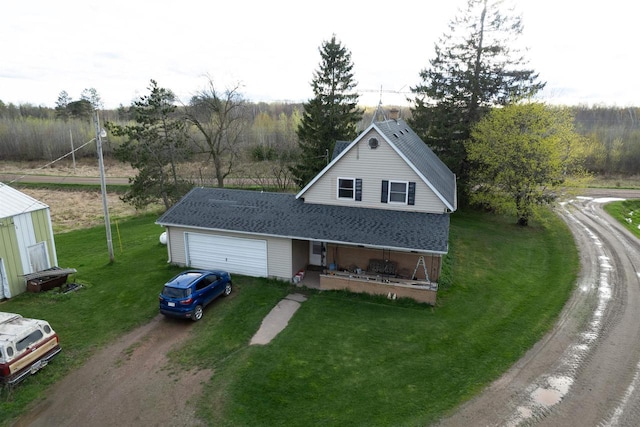 view of front of home featuring a front lawn, a porch, and a garage