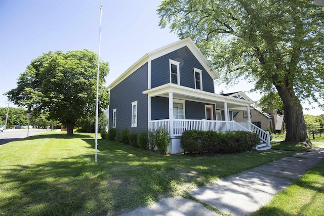 view of front facade featuring covered porch and a front yard