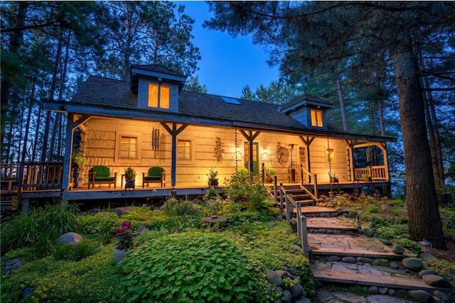 back of house featuring a porch