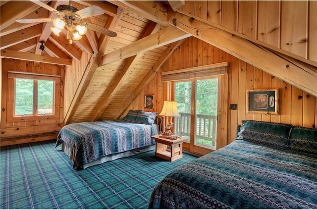 carpeted bedroom with ceiling fan, wood walls, access to exterior, and lofted ceiling with beams