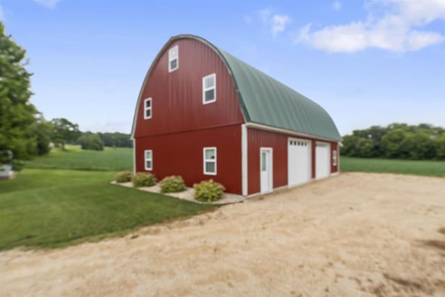 view of outdoor structure with a yard and a garage