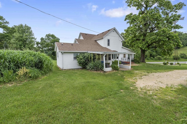 rear view of property with a yard