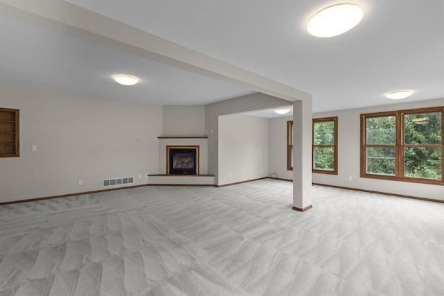 unfurnished living room featuring light carpet