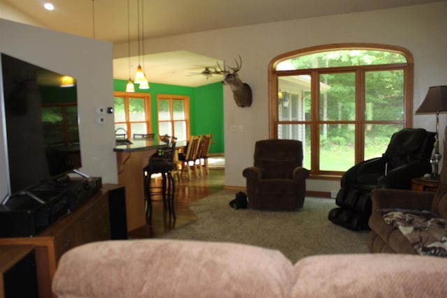 living room featuring ceiling fan and carpet