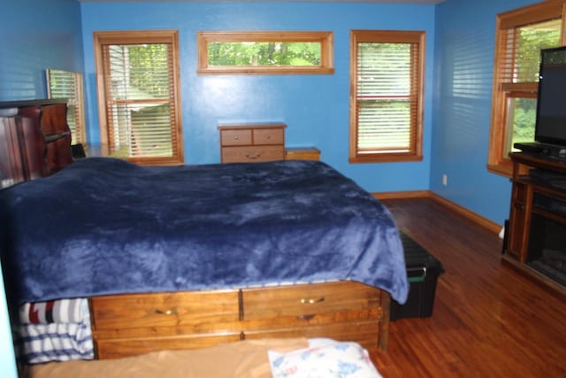 bedroom with dark wood-type flooring