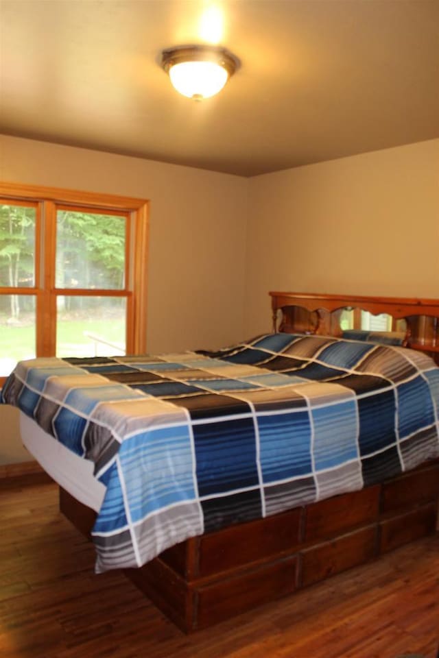 bedroom with wood-type flooring