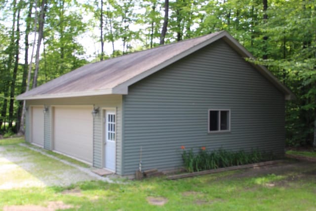 view of home's exterior with a garage and an outdoor structure