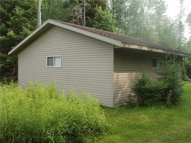 view of side of property with a lawn