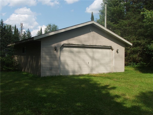 garage featuring a lawn