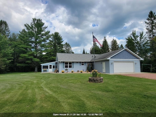 view of front of home featuring a front yard and a garage