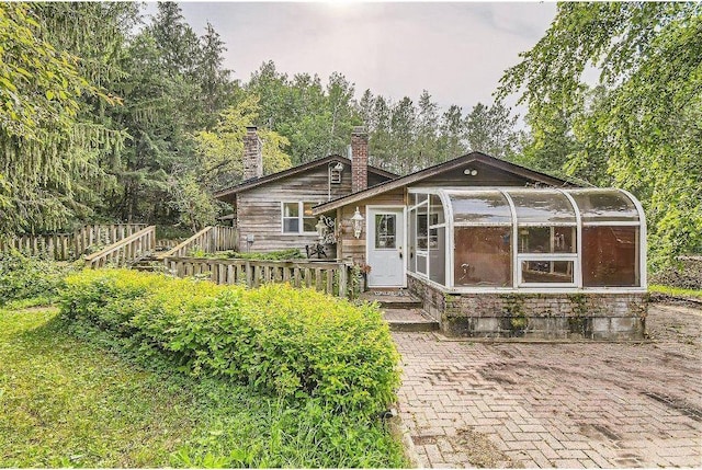 view of front of home featuring a sunroom