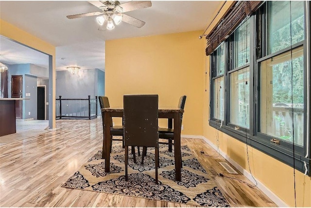 dining space featuring light hardwood / wood-style flooring and ceiling fan