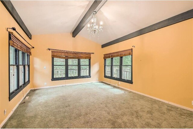 unfurnished room with a chandelier, lofted ceiling with beams, and carpet flooring