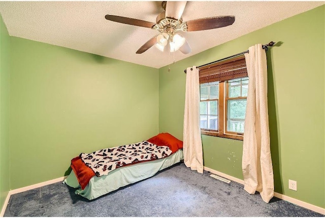 bedroom with carpet flooring, a textured ceiling, and ceiling fan