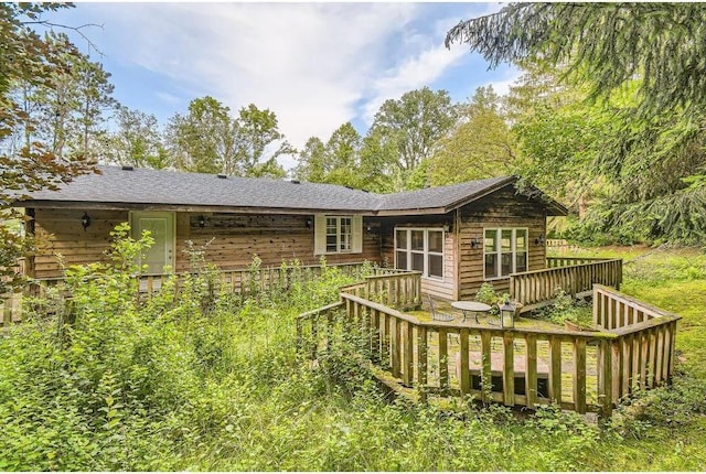 rear view of property with a wooden deck