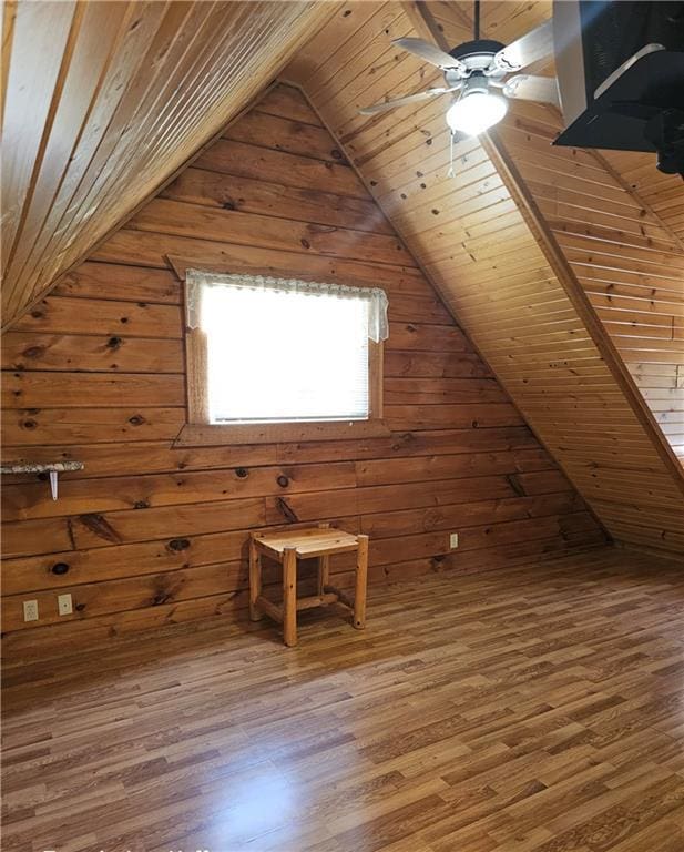 additional living space featuring hardwood / wood-style floors, wooden ceiling, and wood walls