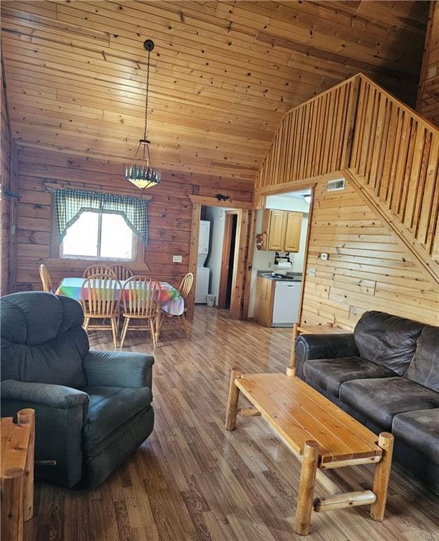 living room featuring wood-type flooring, wood walls, and wood ceiling