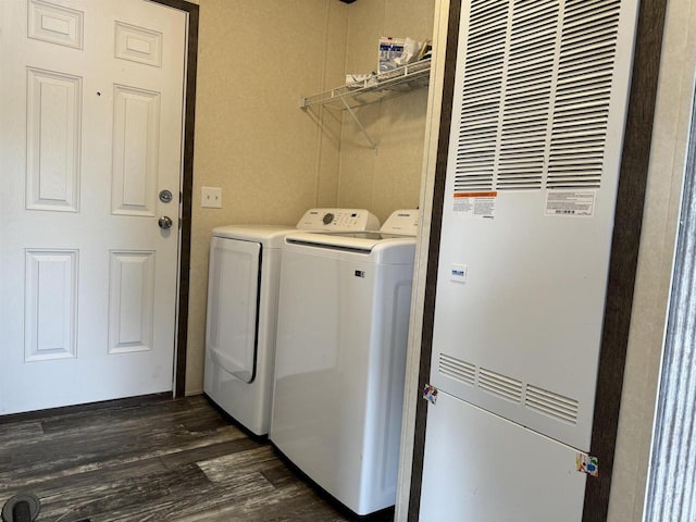 laundry room featuring washing machine and dryer and dark wood-type flooring