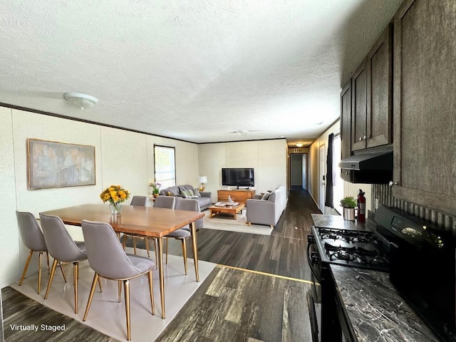 dining room featuring a textured ceiling and dark wood-type flooring