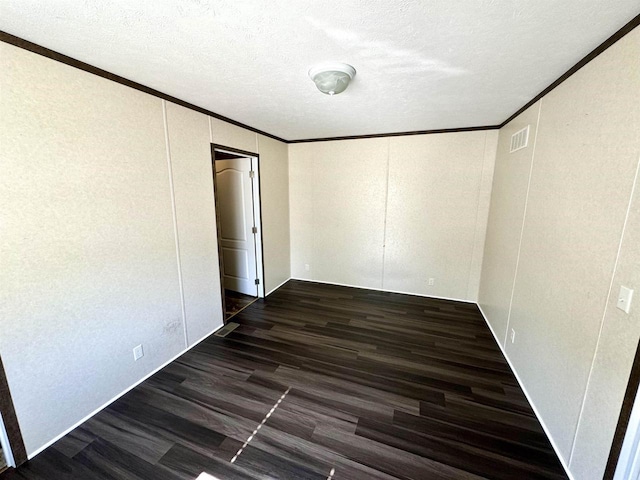 unfurnished bedroom featuring crown molding, dark wood-type flooring, and a textured ceiling