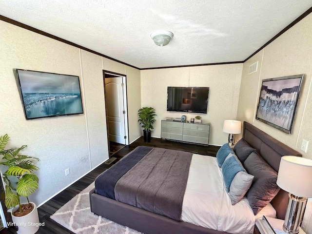 bedroom featuring ornamental molding, a textured ceiling, and dark wood-type flooring