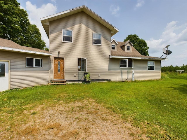 rear view of house with a yard