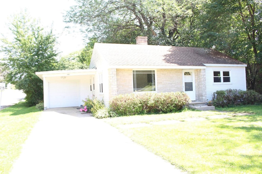 ranch-style home featuring a front yard and a garage