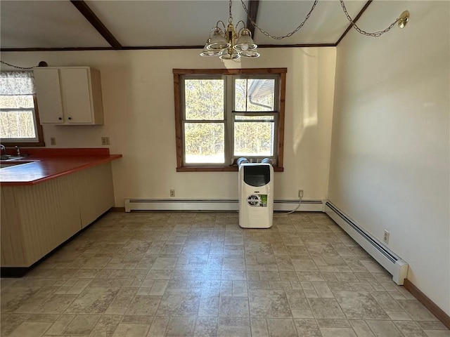 unfurnished dining area with sink, a notable chandelier, and a baseboard heating unit