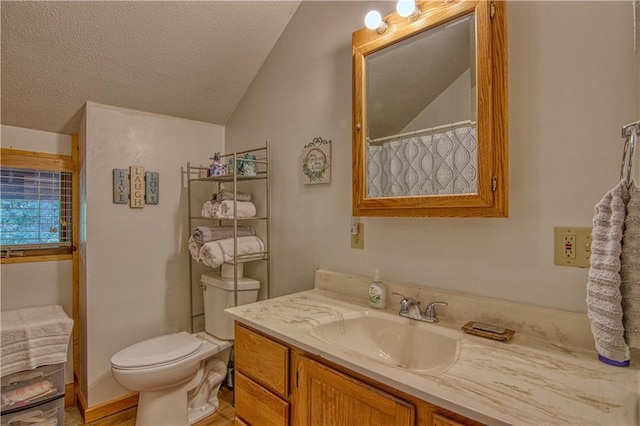 bathroom featuring walk in shower, a textured ceiling, vanity, toilet, and lofted ceiling