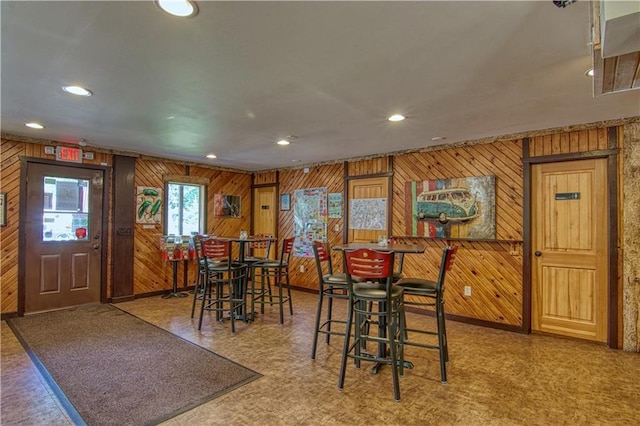 dining room featuring wood walls