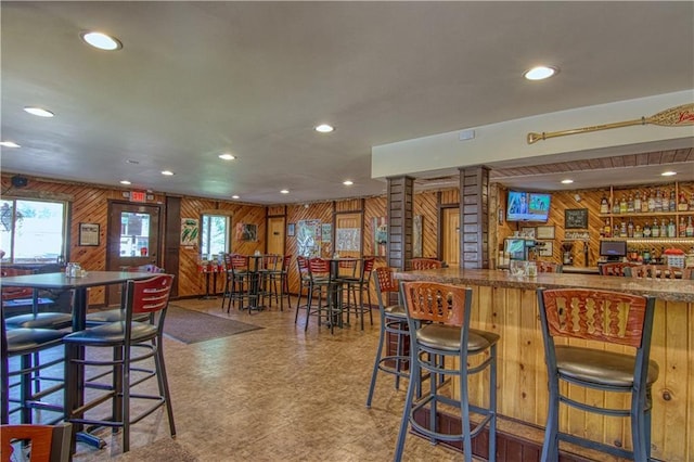 bar with decorative columns and wooden walls