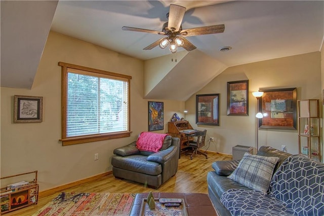 living room with ceiling fan, vaulted ceiling, and light hardwood / wood-style flooring